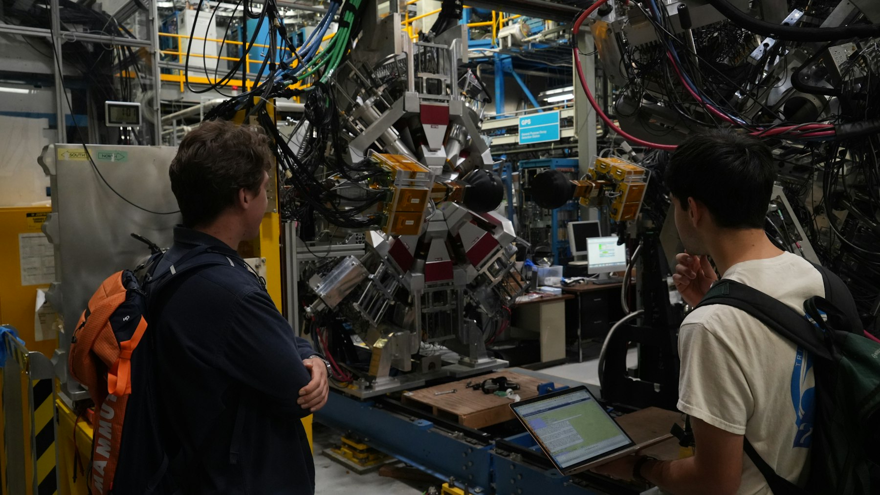 Researchers examining advanced technical equipment in a research facility